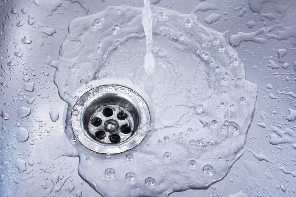 Water pouring down clear drain in kitchen sink