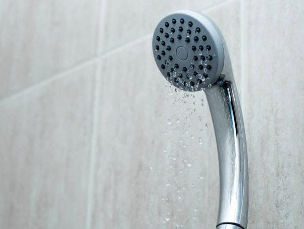 A portable shower emits water at a low-pressure, which is one of many signs of a common tankless water heater problem.